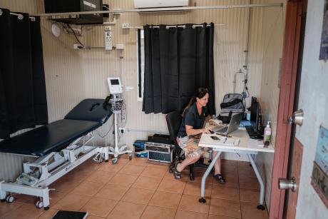 Nurse at desk in clinic room